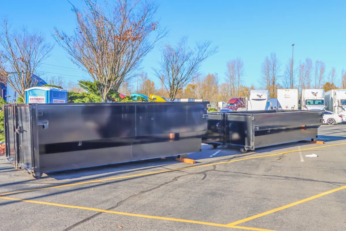 Professional dumpster rental service with roll-off container on residential driveway in La Porte